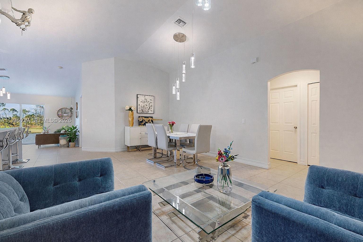 2625 40th Avenue Southeast Naples, FL 34117 - Photo 6 of 81 a living room with furniture and a table