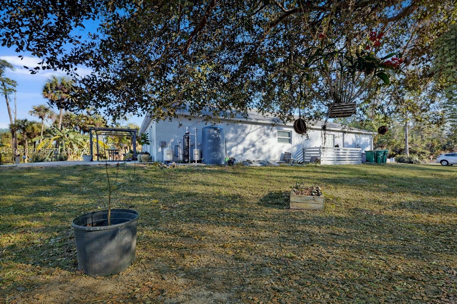 2625 40th Avenue Southeast Naples, FL 34117 - Photo 62 of 81 a view of a fountain in front of a house with a big yard