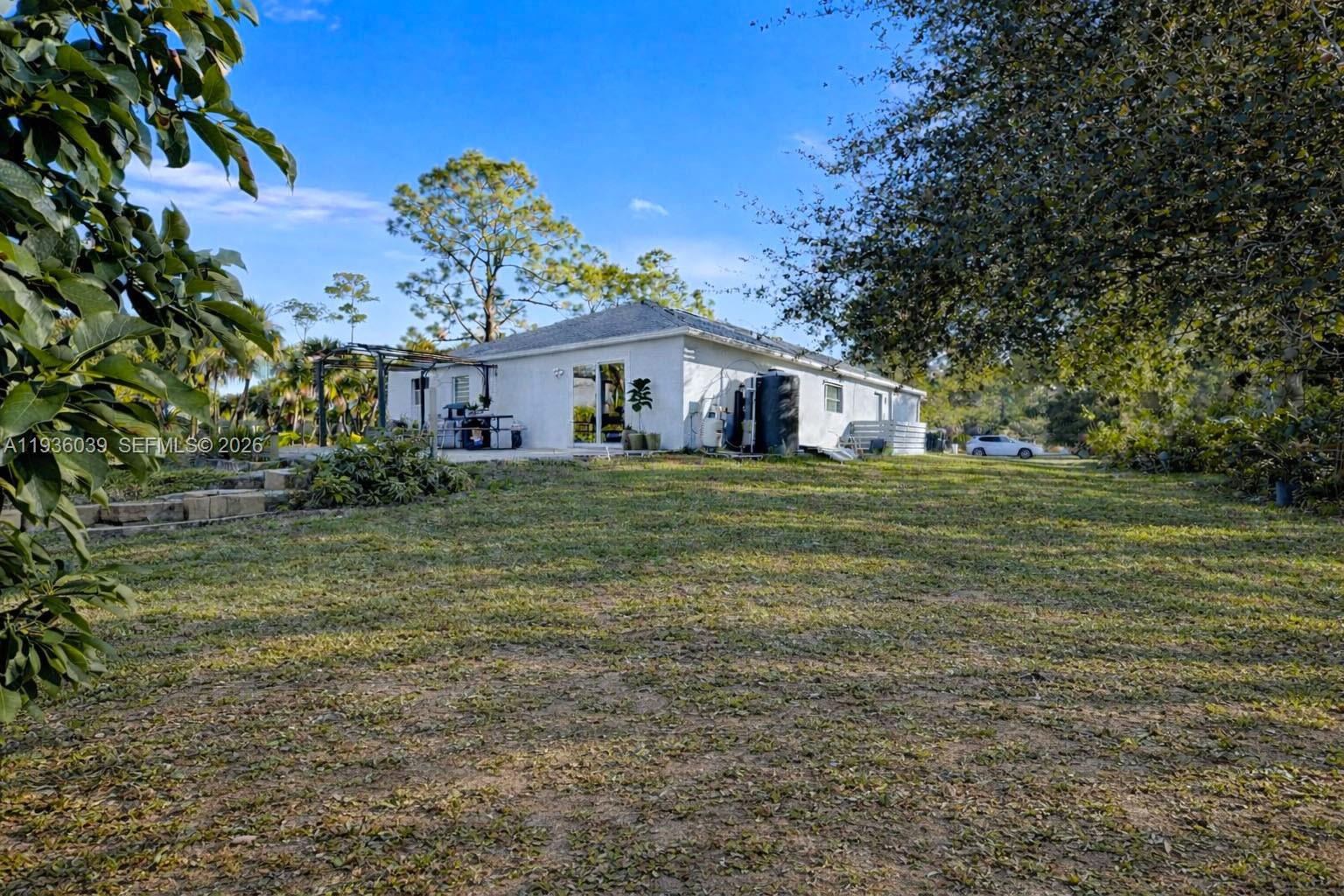 2625 40th Avenue Southeast Naples, FL 34117 - Photo 67 of 81 a view of a house with a yard