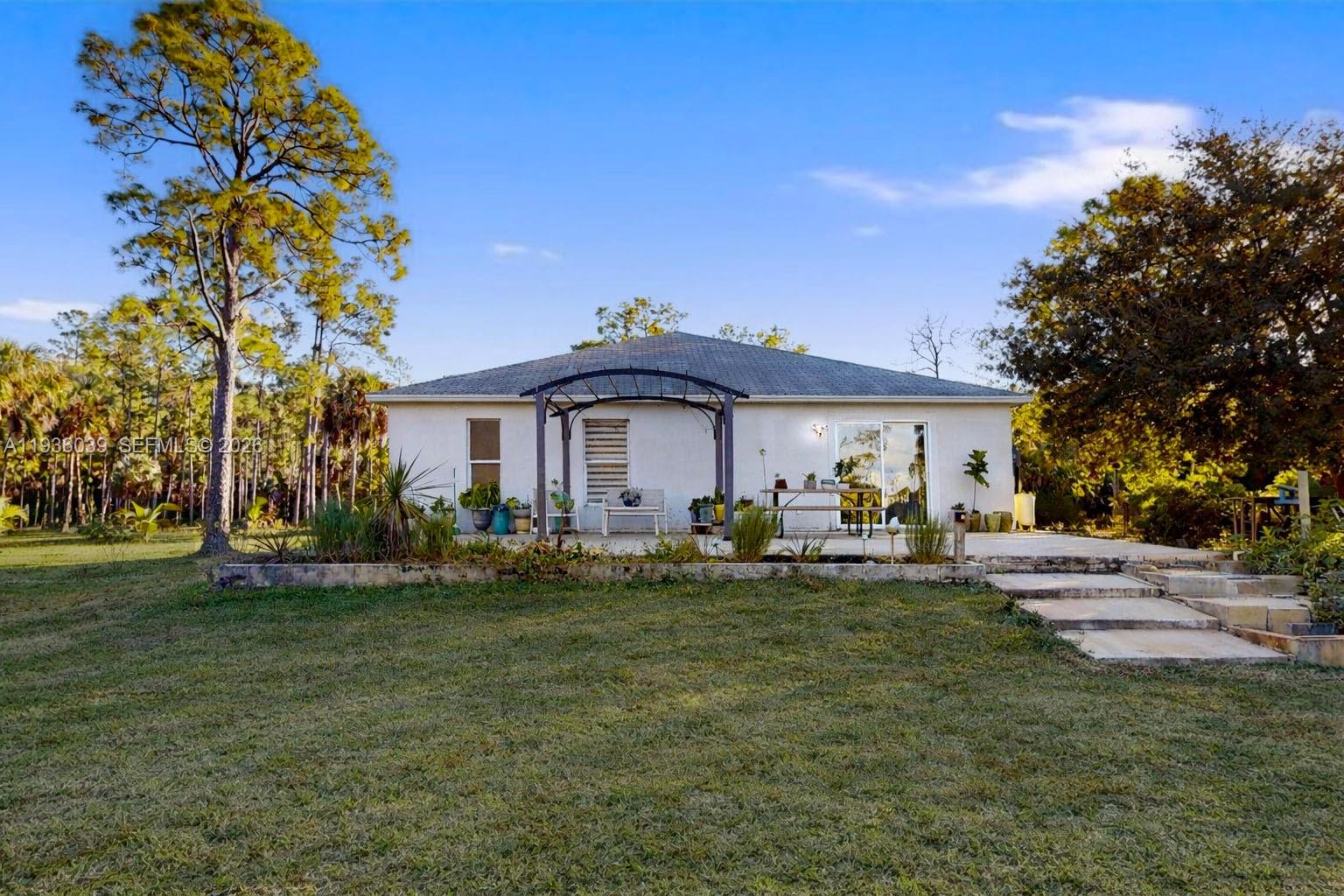 2625 40th Avenue Southeast Naples, FL 34117 - Photo 73 of 81 a front view of a house with a garden