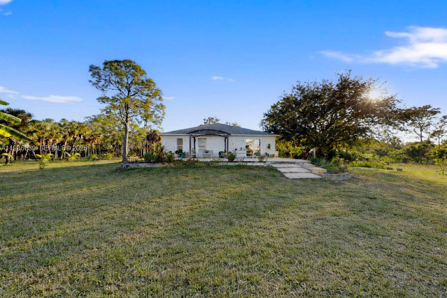 2625 40th Avenue Southeast Naples, FL 34117 - Photo 74 of 81 a front view of a house with a yard