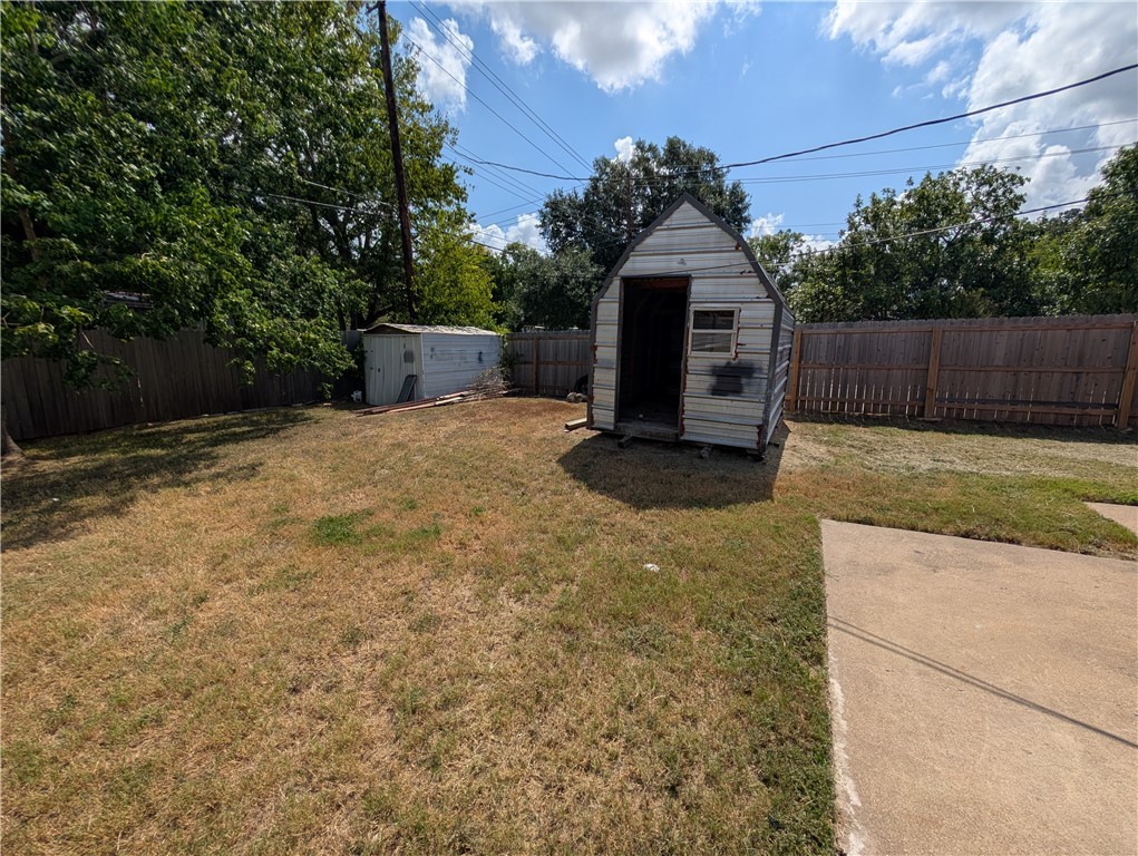 2901 Minnesota Avenue Bryan, TX 77803 - Photo 16 of 16 Fenced backyard featuring a storage shed