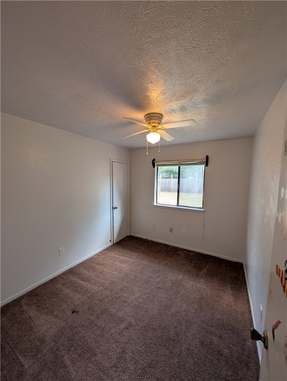 2901 Minnesota Avenue Bryan, TX 77803 - Photo 7 of 16 Spare room featuring dark colored carpet, a textured ceiling, and a ceiling fan