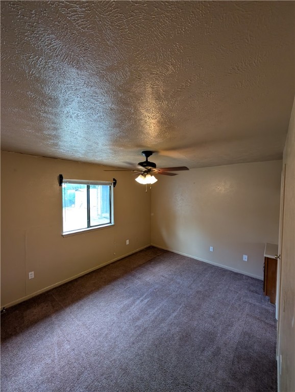 2901 Minnesota Avenue Bryan, TX 77803 - Photo 8 of 16 Carpeted spare room featuring a textured ceiling and ceiling fan