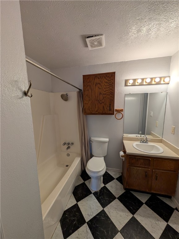 2901 Minnesota Avenue Bryan, TX 77803 - Photo 9 of 16 Full bathroom with shower / tub combo, vanity, a textured ceiling, and a textured wall