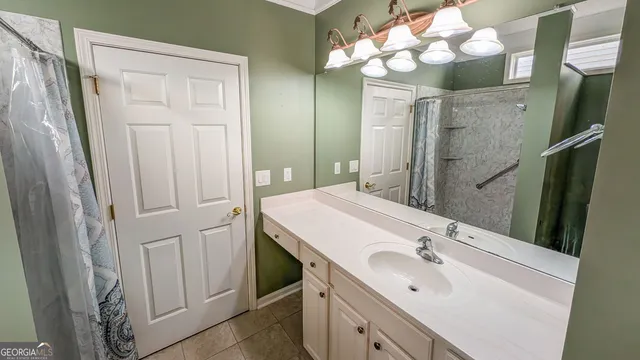 a bathroom with a sink vanity and a mirror