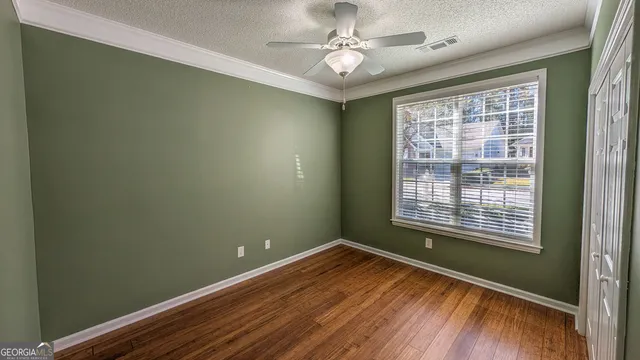 a view of a room with wooden floor and windows