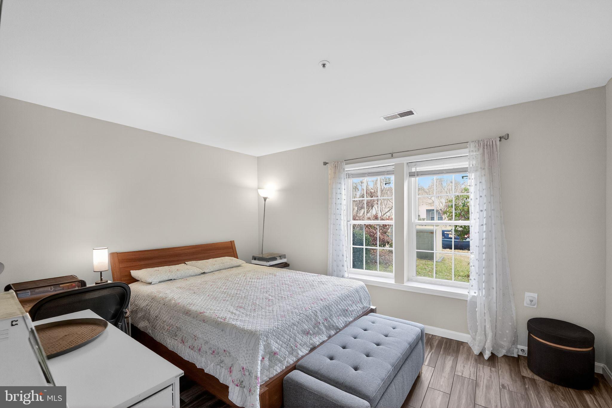14229 Jib Street, Unit 12 Laurel, MD 20707 - Photo 12 of 17 a bedroom with a bed and wooden floor