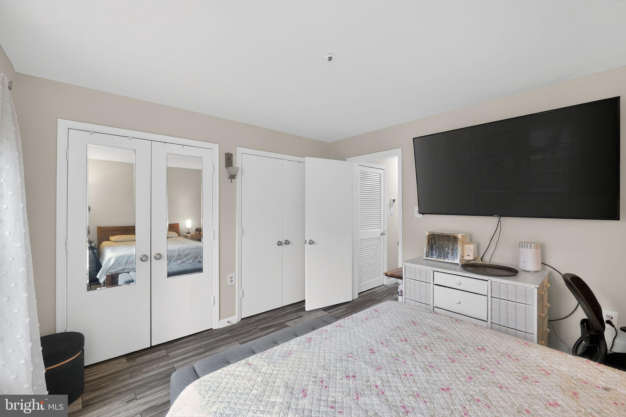 14229 Jib Street, Unit 12 Laurel, MD 20707 - Photo 13 of 17 a bedroom with a bed and a flat screen tv