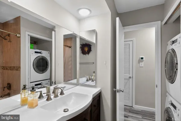 a bathroom with a sink vanity and a mirror
