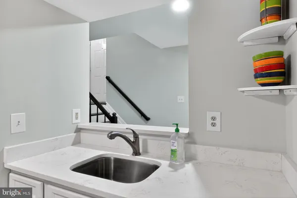 a kitchen with a sink a counter top space and a window