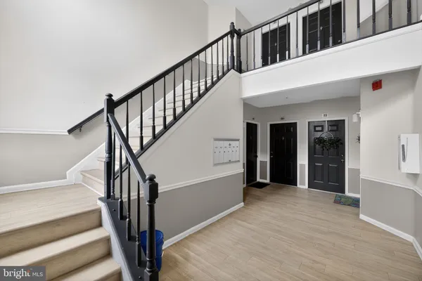 a view of staircase with white walls and a window