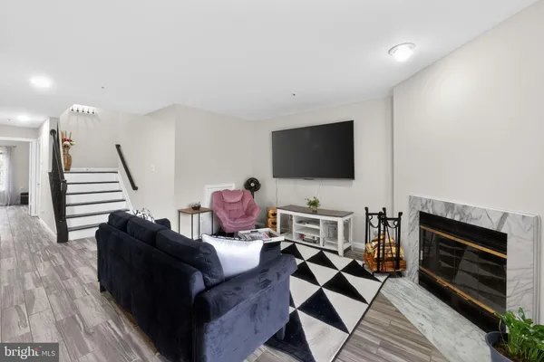 a living room with furniture and a flat screen tv