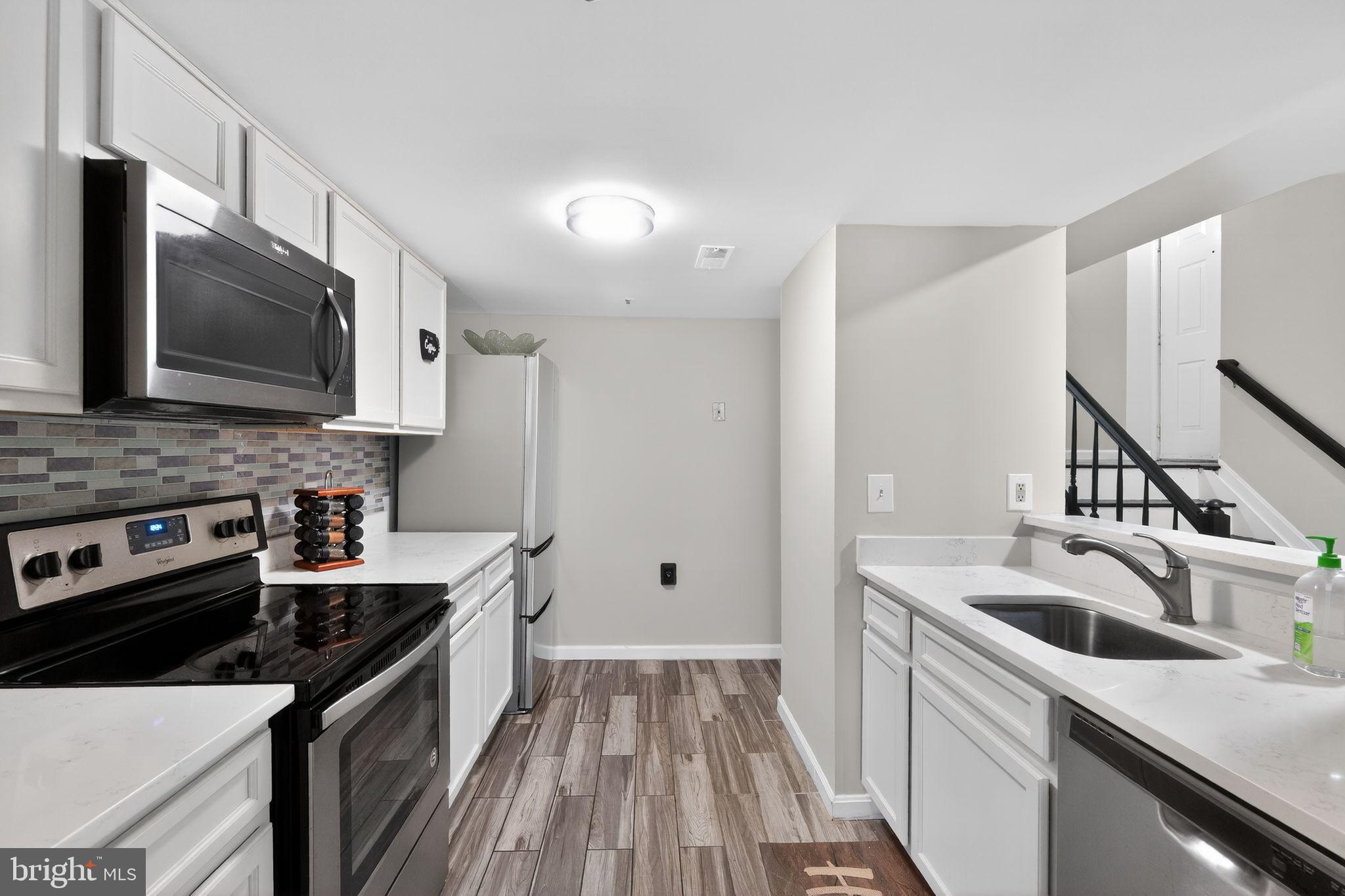14229 Jib Street, Unit 12 Laurel, MD 20707 - Photo 6 of 17 a kitchen that has a sink and a stove top oven