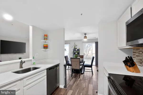 a kitchen with a sink cabinets and wooden floor