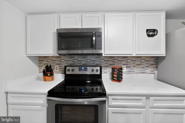 a kitchen with a stove and a microwave