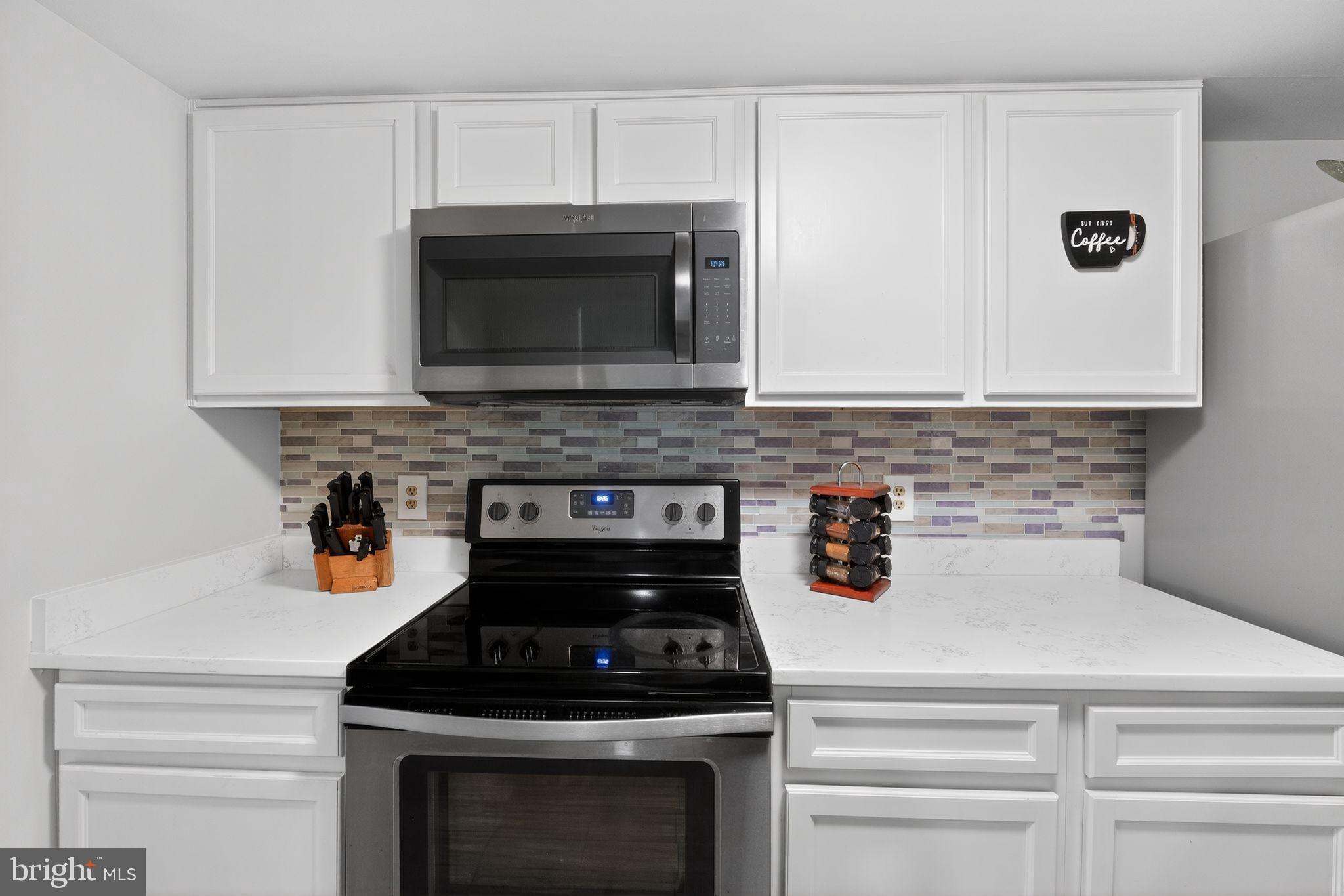 14229 Jib Street, Unit 12 Laurel, MD 20707 - Photo 9 of 17 a kitchen with a stove and a microwave