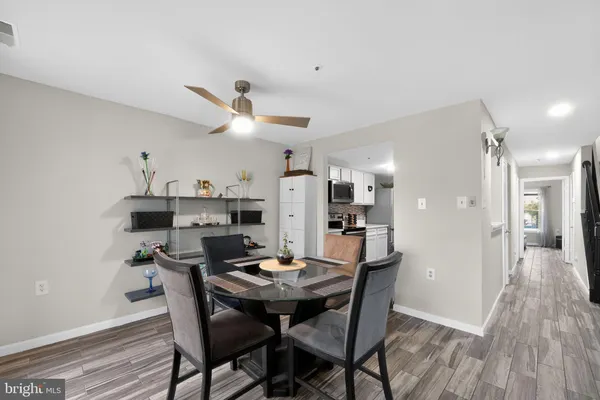 a view of a dining room with furniture and wooden floor