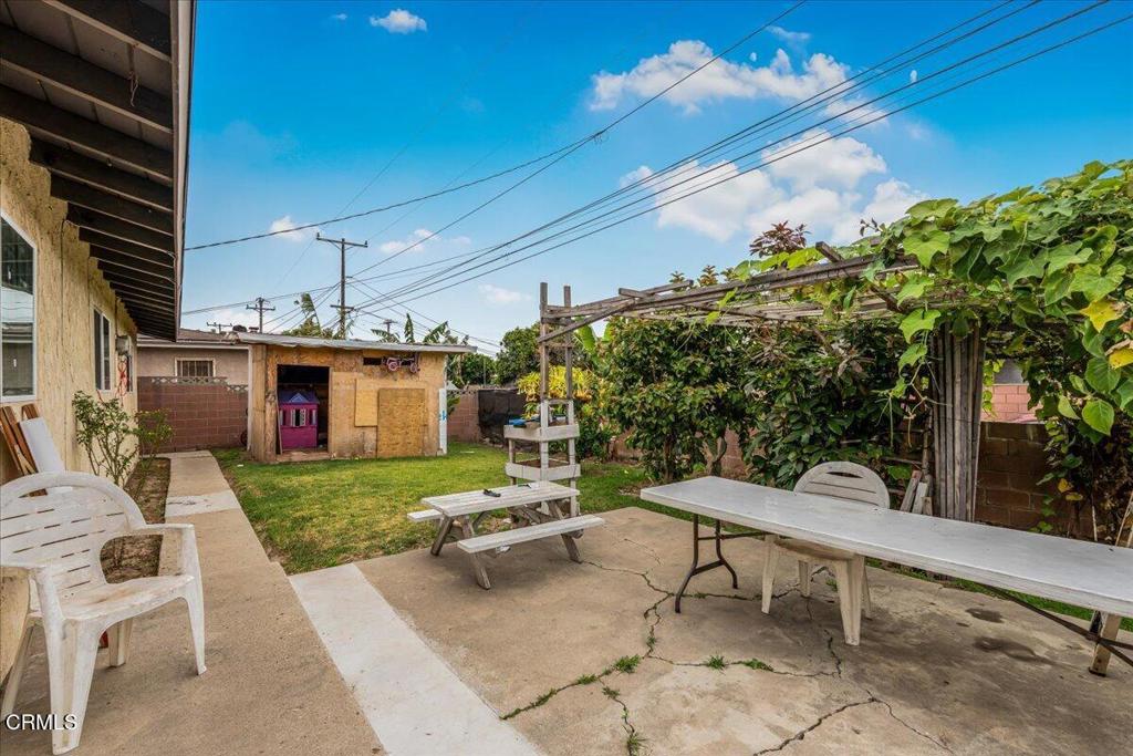 970 Laurel Street West Oxnard, CA 93033 - Photo 25 of 40 a view of a patio with table and chairs with wooden fence and plants