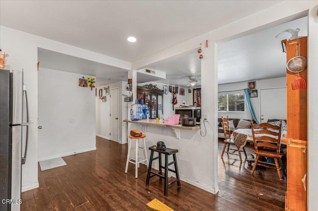 970 Laurel Street West Oxnard, CA 93033 - Photo 7 of 40 a view of a dining room with furniture and wooden floor