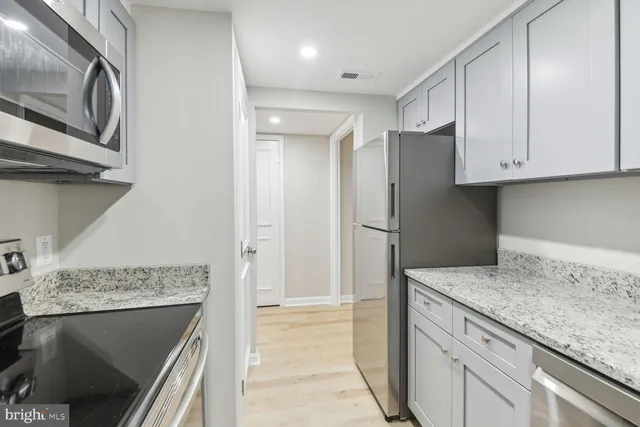 an empty room with wooden floor and door