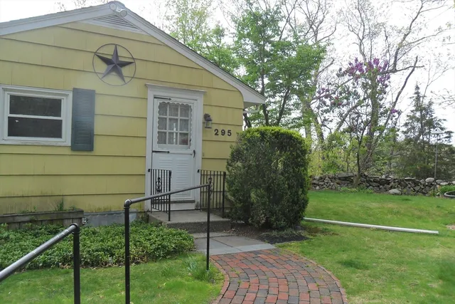 a backyard of a house with plants and trees