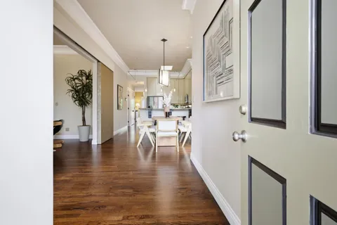 a view of a living room with furniture and wooden floor