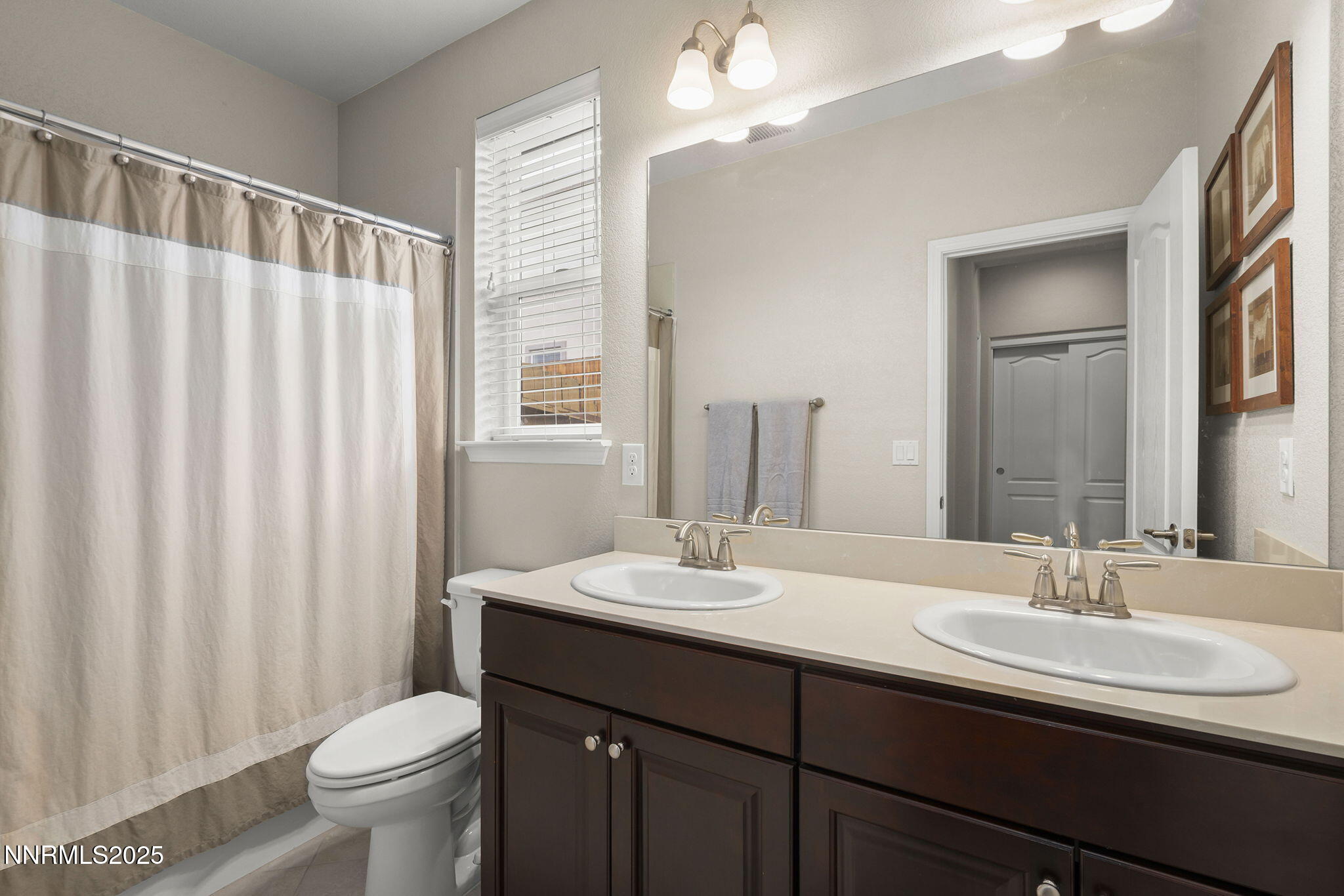 2835 Tobiano Drive Reno, NV 89521 - Photo 23 of 33 a bathroom with a double vanity sink toilet and a mirror