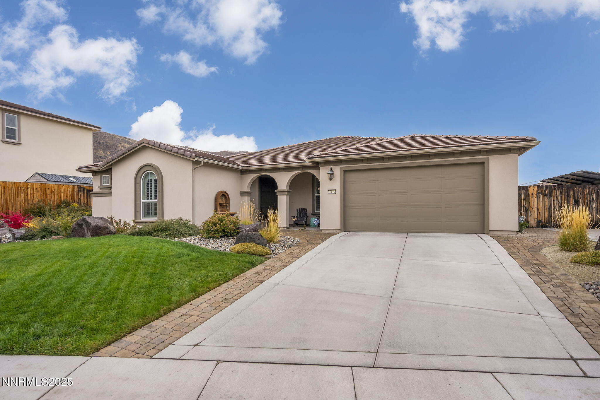 2835 Tobiano Drive Reno, NV 89521 - Photo 3 of 33 a front view of a house with a yard and garage
