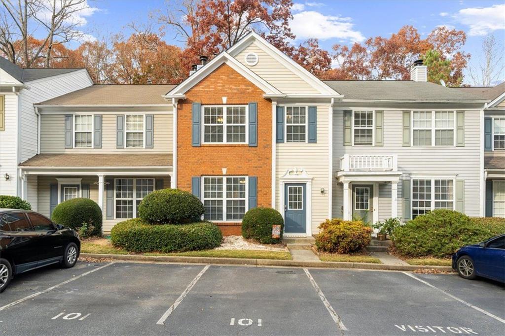 9155 Nesbit Ferry Road, Unit 101 Alpharetta, GA 30022 - Photo 1 of 1 front view of a house with a yard
