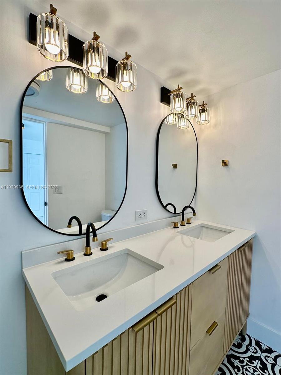 629 Southwest 4th Street Hallandale Beach, FL 33009 - Photo 19 of 27 a bathroom with a sink and a mirror