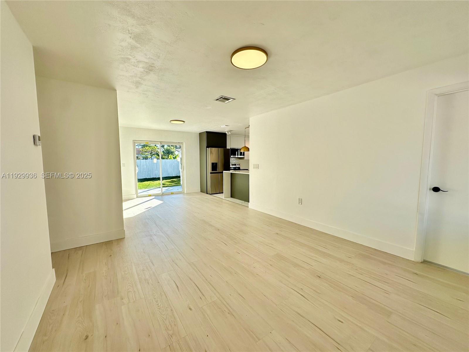 629 Southwest 4th Street Hallandale Beach, FL 33009 - Photo 6 of 27 a view of a kitchen with a sink and a refrigerator