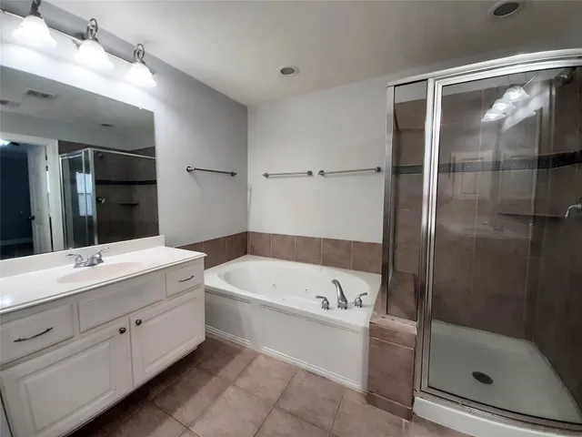 an empty room with a ceiling fan and a window