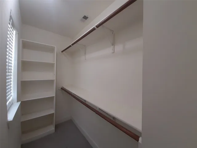 a room with cabinets and a ceiling fan