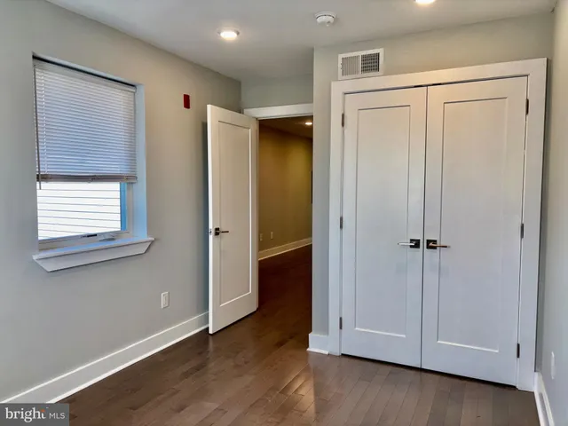 a view of a small space with wooden floor and a window