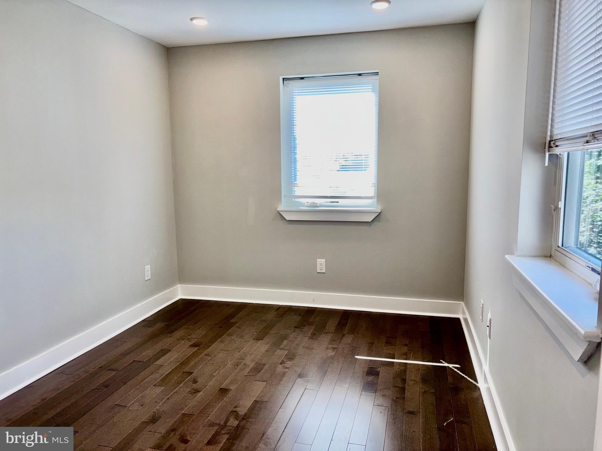 5334-36 Cedar Avenue, Unit 7G Philadelphia, PA 19143 - Photo 12 of 14 a view of a small space with wooden floor and a window