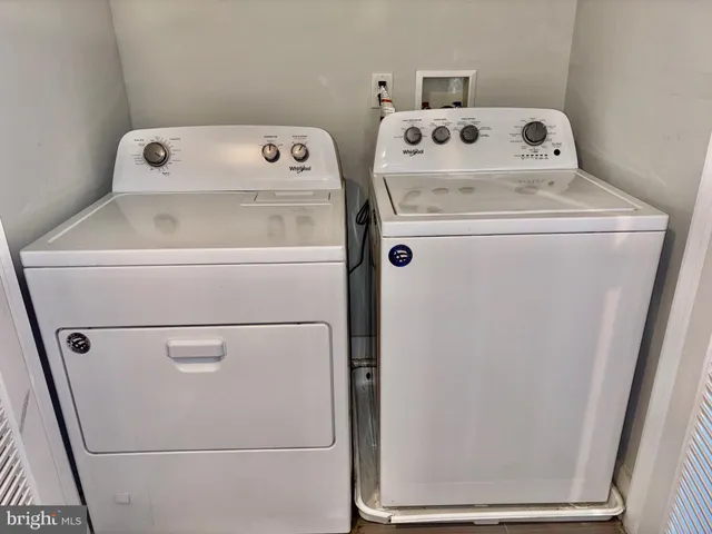 a kitchen with stainless steel appliances granite countertop a sink a stove cabinets and wooden floor