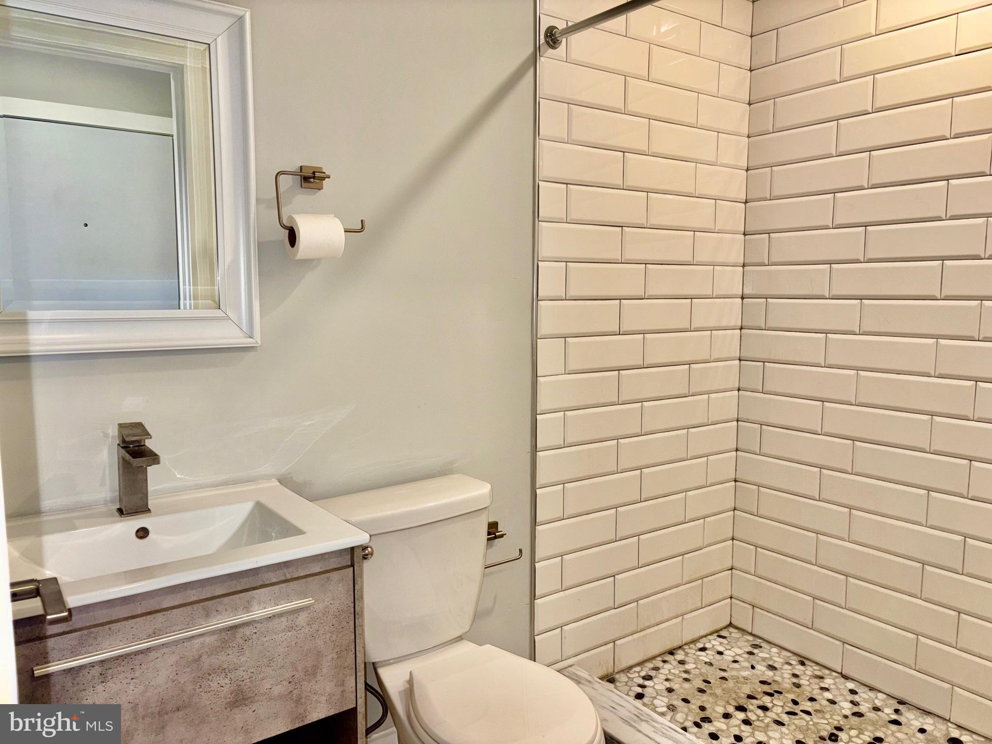5334-36 Cedar Avenue, Unit 7G Philadelphia, PA 19143 - Photo 9 of 14 a bathroom with a sink and a toilet