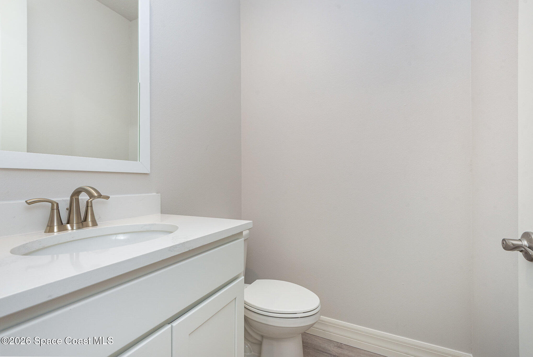 150 First Light Circle Cocoa, FL 32922 - Photo 11 of 28 a bathroom with a sink a toilet and a mirror