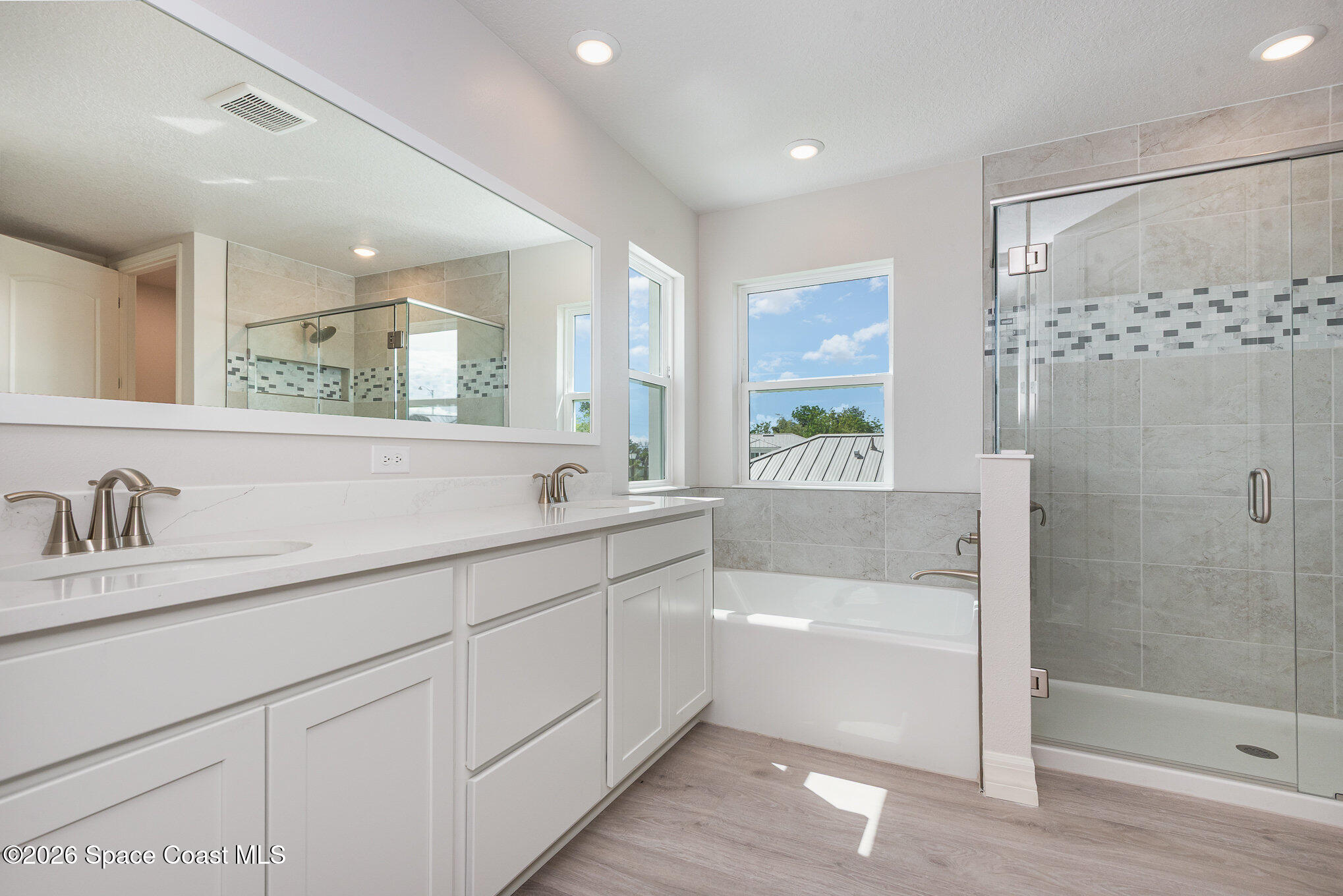 150 First Light Circle Cocoa, FL 32922 - Photo 20 of 28 a bathroom with a bathtub a shower a sink and a window