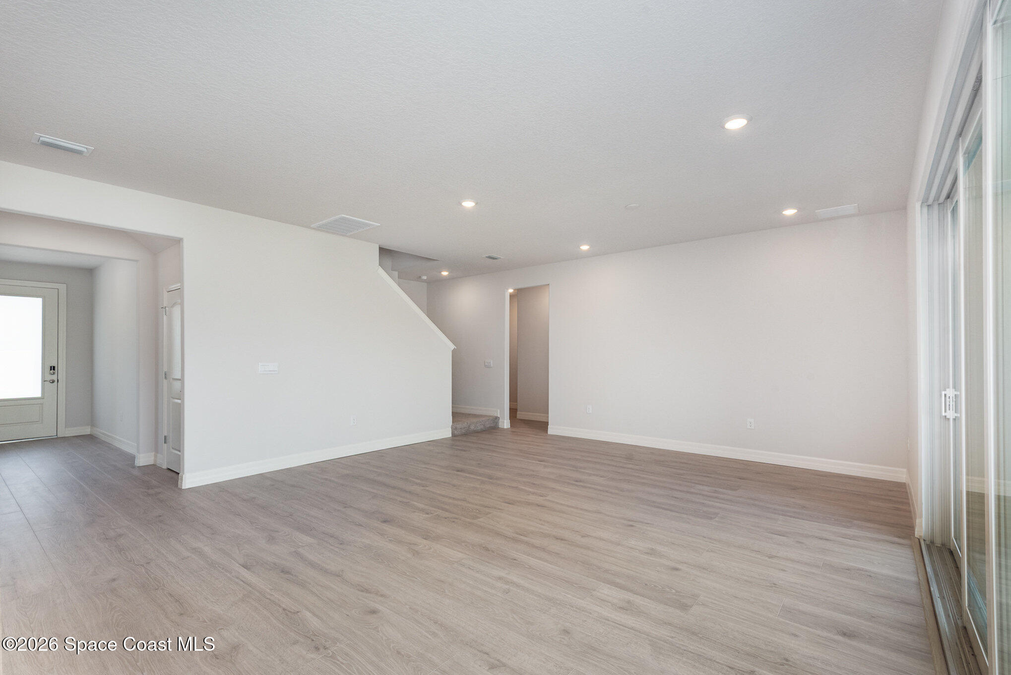 150 First Light Circle Cocoa, FL 32922 - Photo 5 of 28 a view of an empty room with wooden floor