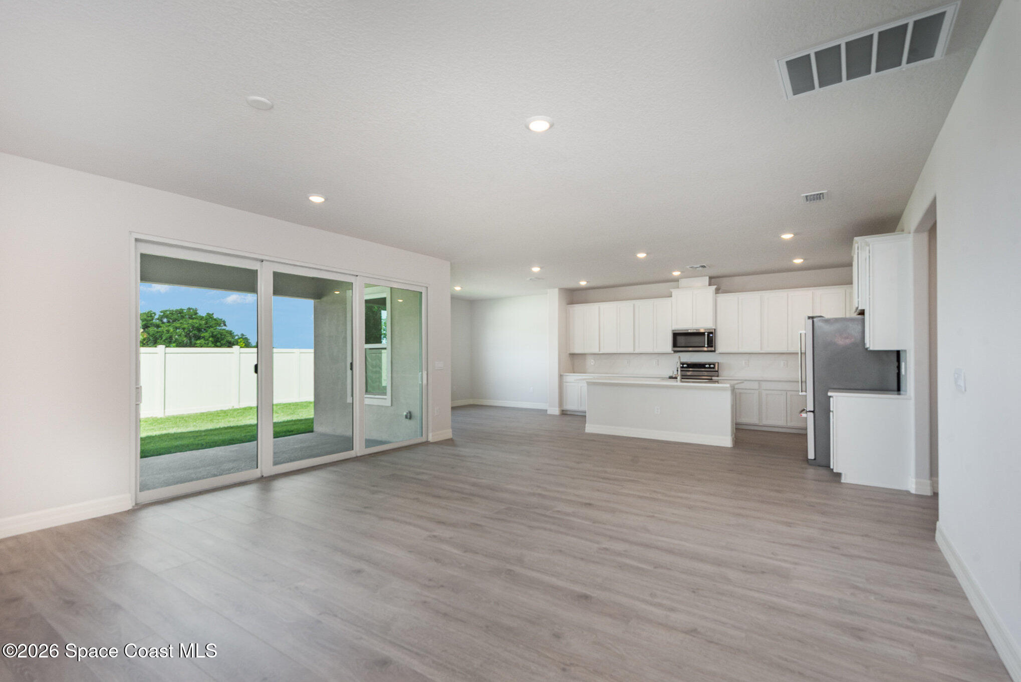 150 First Light Circle Cocoa, FL 32922 - Photo 6 of 28 a view of kitchen with kitchen island wooden floor and refrigerator