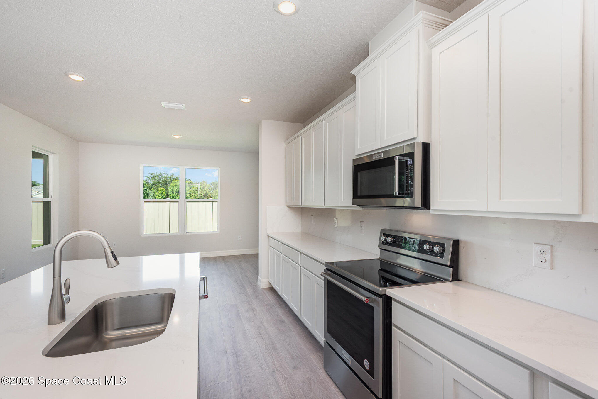 150 First Light Circle Cocoa, FL 32922 - Photo 9 of 28 a kitchen with stainless steel appliances granite countertop a sink a stove top oven a counter space and cabinets