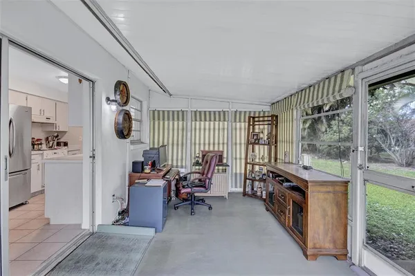 a living room with furniture and large windows