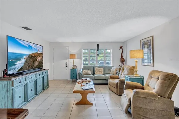 a living room with furniture a rug and a window