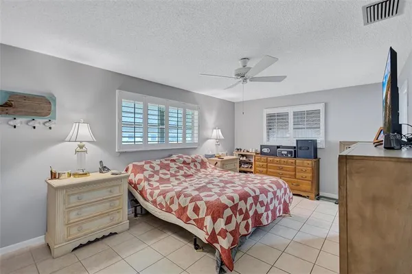 a bedroom with a large bed and a dresser