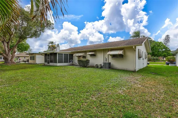 a view of a house with yard and sitting area