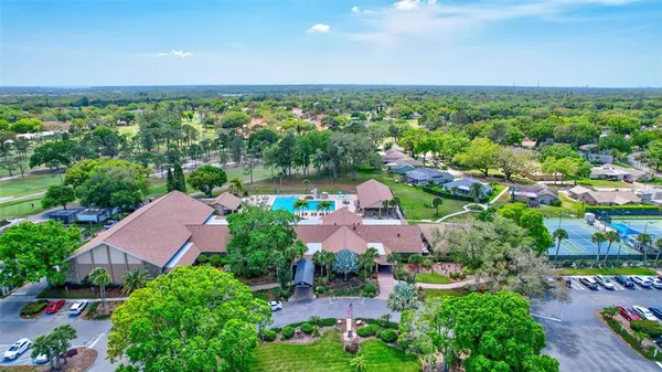 an aerial view of a house with garden space and ocean view