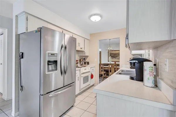 a kitchen with stainless steel appliances a refrigerator sink and stove