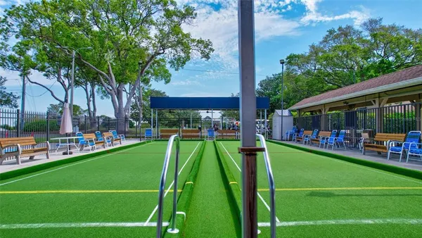 a view of an ocean with boats and trees in the background